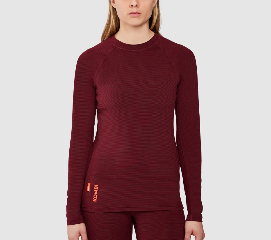 Maroon long-sleeve top worn by a person on a light gray background