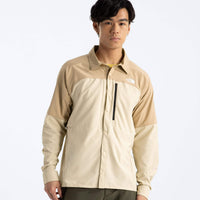 Person wearing a beige and white jacket on a white background