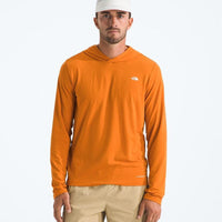 Man wearing an orange long-sleeve shirt with a logo on a white background