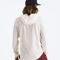 Person wearing a white hoodie and maroon pants with a black cap on a white background