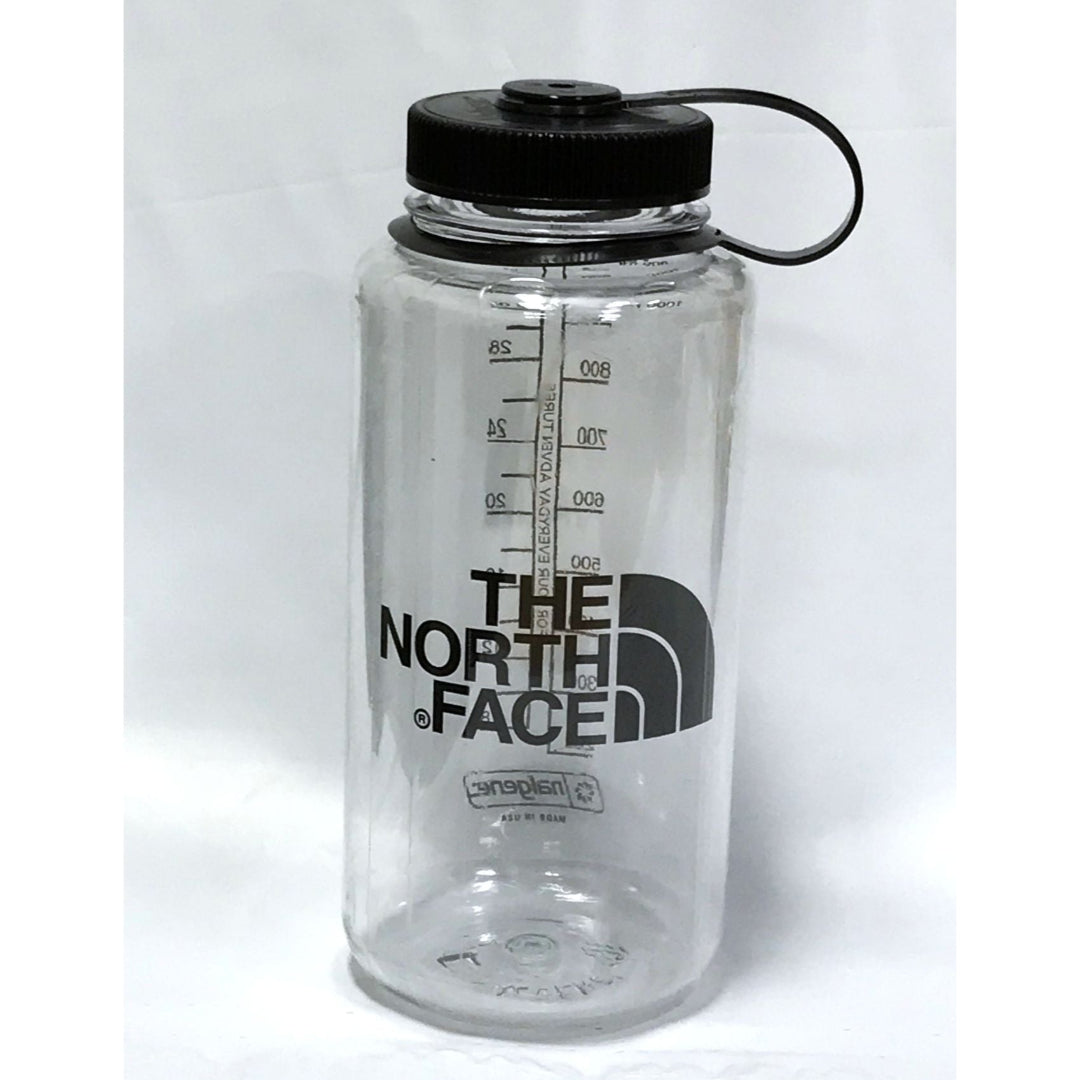 Clear water bottle with black lid and The North Face logo on a white background