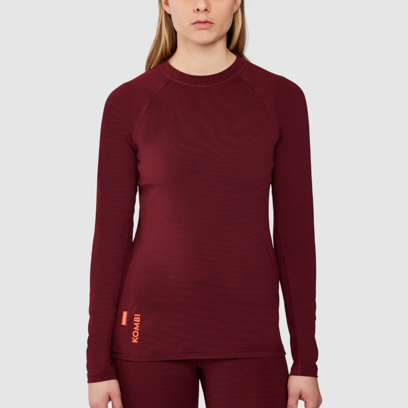 Maroon long-sleeve top worn by a person on a light gray background