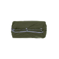 Green compression bag with gray straps on a white background