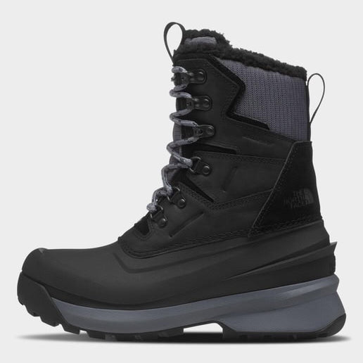 Black winter boot with gray sole on a white background