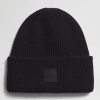 Black beanie with a brand patch on a light gray background