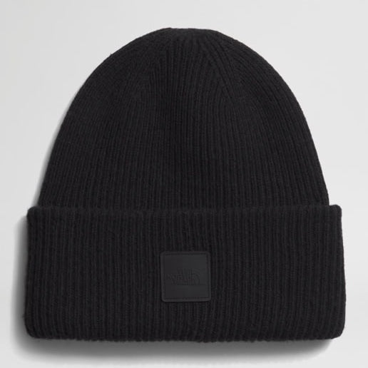 Black beanie with a brand patch on a light gray background