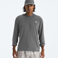 Man wearing a gray hoodie with a logo on a white background