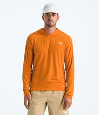 Man wearing an orange long-sleeve shirt with a logo on a white background