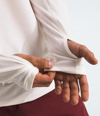 Person wearing a white shirt, showing a close-up of their hands.