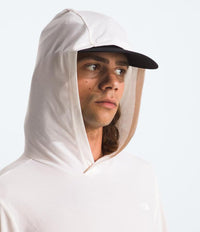 Person wearing a white sun hoodie with hood up against a light gray background
