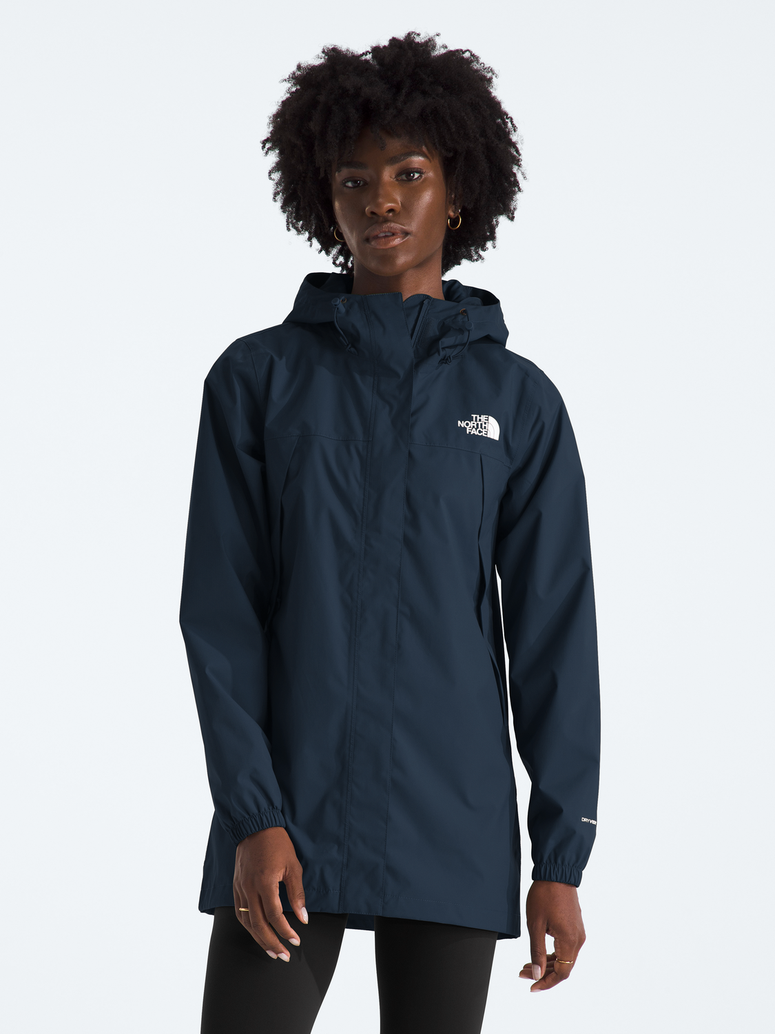 Person wearing a navy blue raincoat with a brand logo on a white background