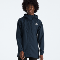 Person wearing a navy blue raincoat with a brand logo on a white background